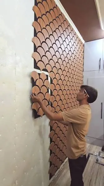 Technician installing acoustic panels for workplace noise control